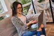© Тарас Нагирняк - Preety freelancer girl working at home in headphones with laptop pointing it