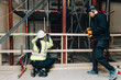 © Maskot - Full length of male and female worker together at construction site