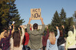 © New Africa - Group of people with posters protesting against climate change outdoors, back view
