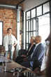 © Maskot - Confident businesswoman discussing with male and female investors at office