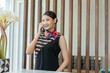 Young Asian woman receptionist smiling and talking welcome on telephone with customers at the hotel.Reception desk