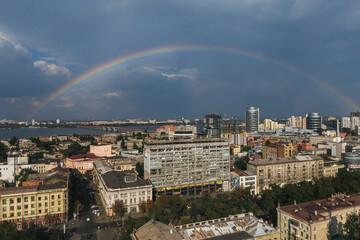 beautiful double rainbow in the city after the rain. photo from the drone. rainbow against the blue 