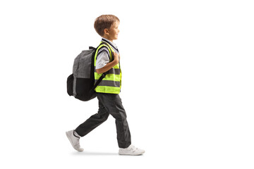 Poster - Full length profile shot of a schoolboy in a uniform and safety vest walking