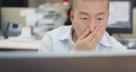 Japanese Businessman executive working at computer using device connected to global data in busy corporate office very worried about investment
