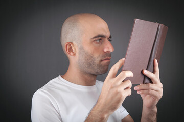Wall Mural - Caucasian man reading book in office.