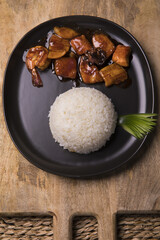 Sticker - top view of chinese cuisine dish with seafood and rice served on a black plate on a cutting board