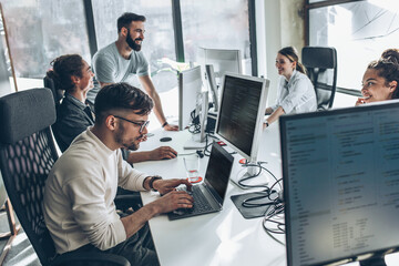 group of programmers and software developers working on a new project at the office.