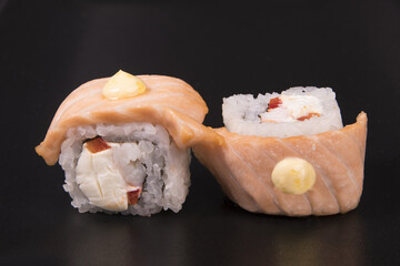 Sticker - Closeup of Philadelphia sushi rolls with cheese, salmon and shrimp on a black background