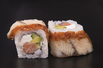 Poster - Closeup of Canadian sushi rolls on a black background