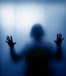 © F Armstrong Photo - Sihouette of Woman touching highly diffused blue frosted glass