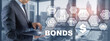© Funtap - Corporate Bonds concept. Man presses his finger on the inscription Bonds