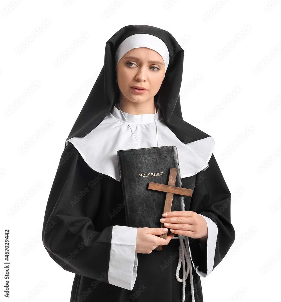 Young nun with Bible on white background