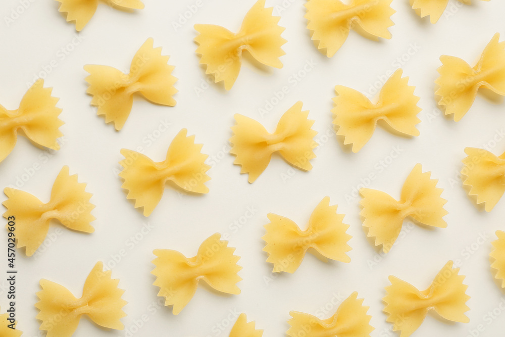 Uncooked farfalle pasta on light background
