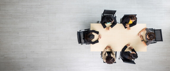 Top view of meeting conference wooden table with six executives businesswomen sitting on each chairs discussing and talking business in team work in meeting room