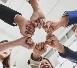 Wall Mural - Selective focus on multiple business women's hands in formal suits put together during business meeting with blurry faces in background. Concept for business meeting