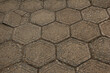 The texture of a sidewalk lined with hexagonal paving slabs.