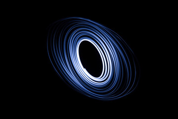 Long exposure of a tiny light swirling over the camera