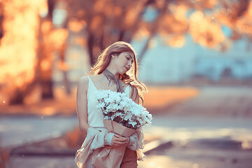 Wall Mural - girl holding a bouquet of flowers a walk in the park / romantic young beautiful cute model, love fee
