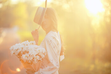 Wall Mural - happy romantic girl in a straw hat / young model in a dress summer day, happiness woman