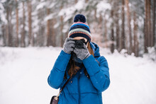 Woman Taking Picture On Photo Camera In Winter Woods