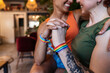 © ADDICTIVE STOCK - Smiling anonymous homosexual couple with drink embracing on sofa at home