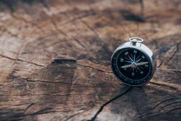 magnetic compass on old brown wood. vintage still life. sailing accessories. travel, navigation, col