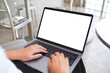 © Farknot Architect - Mockup image of a woman using and typing on laptop computer with blank white desktop screen