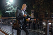 © antgor - Businessman using smartphone at the night city