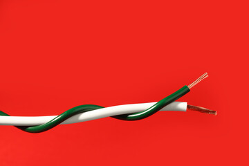 Two different electrical wires on red background. Space for text