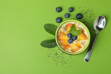 Wall Mural - Concept of healthy food with peach yogurt on green background