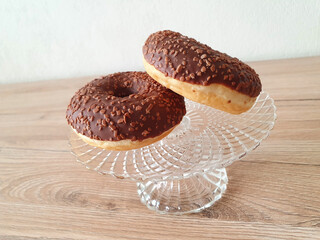 Wall Mural - Closeup shot of chocolate doughnuts on a glass plate container