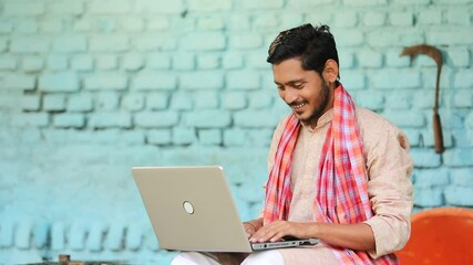 Wall Mural - Technology concept : Indian farmer using laptop at home