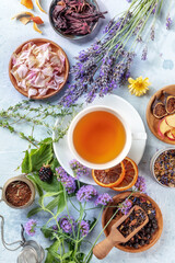 Poster - Herbal tea ingredients. Herbs, flowers, and fruit, shot from the top with a cup of tea, a flat lay