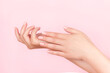 © MariiaDemchenko - Female hands with beautiful manicure - pink nude nails on pink background. Nail care concept