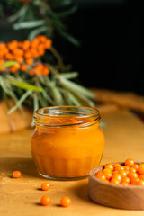 Sea buckthorn berries and sea buckthorn jam jar