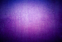 Old Purple Wall In Spots, Cracks, Stains. Painted Concrete Wall In Abstract Grunge Style Loft. Vintage Lilac Wall Background Texture For Backgrounds, Portraits, Posters.