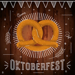 Wall Mural - Isolated pretzel on a wooden background with oktoberfest ornaments