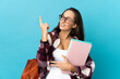 © luismolinero - Young student woman over isolated background pointing up a great idea
