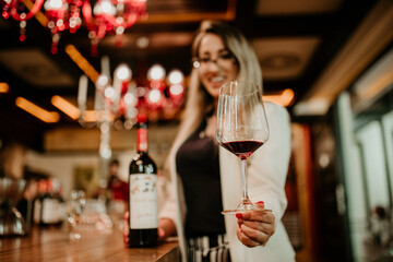 Poster - Shallow focus of a young woman in the cellar tasting wine