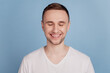 © Tetiana - Photo of young handsome man happy positive smile close eyes dream cheerful toothy isolated over blue color backgrund