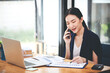 © Daenin - Business woman talking on the phone, laptop, computer, business technology concept.