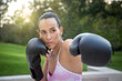 © luisrojasstock - Young caucasian woman giving a punch with boxing gloves