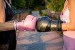 © luisrojasstock - Young caucasian women crashing boxing gloves on a bridge at sunset