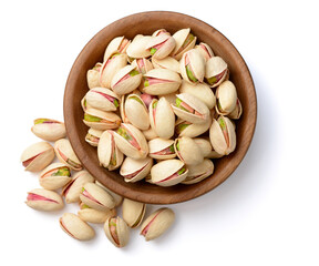 Sticker - pistachios nuts in the wooden plate, isolated on white, top view