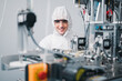 © SEVENNINE_79 - Scientists wearing protective clothing Inspect mask making machines in a laboratory at an industrial plant. Anti-virus production warehouse. concept of safety and prevention coronavirus covid-19.
