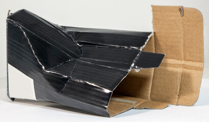 Torn and crushed black box. Horizontal.