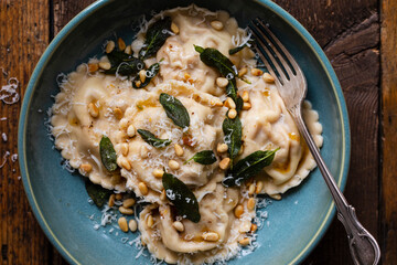 Wall Mural - Home made pumpkin ravioli with crispy sage leaves and pinenuts