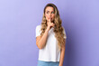 © luismolinero - Young Brazilian woman isolated on purple background showing a sign of silence gesture putting finger in mouth