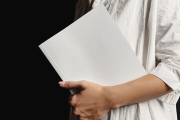 Woman holding softcover book mockup