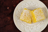 Fototapeta Do przedpokoju - Homemade lemon bars dessert on a white plate on the table